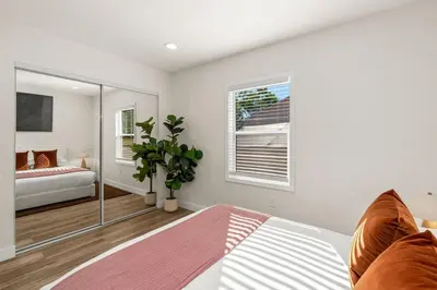a living room with a bed and a window at Palm Haven Retreat Cozy 2BR Near Downtown in San Diego