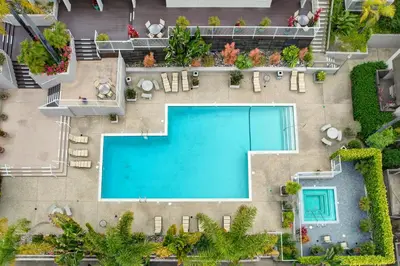 an overhead view of a swimming pool with chaise lounge chairs at La Jolla Lifestyle in San Diego