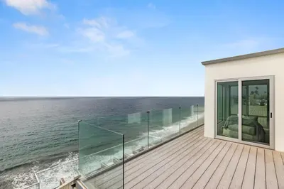 a balcony with a view of the ocean at Encinitas Shores - Beachfront, Ocean View & Patio in Encinitas