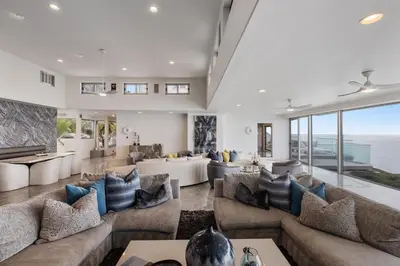 a living room filled with furniture and a large window at Encinitas Shores - Beachfront, Ocean View & Patio in Encinitas
