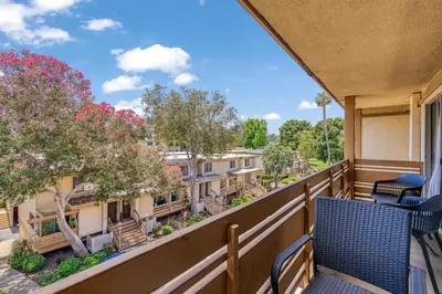 a balcony with chairs and a view of buildings at Luxury Condo Resort Amenities - Pool, Pickleball in San Diego