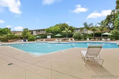 a swimming pool with a chair in a resort at Luxury Condo Resort Amenities - Pool, Pickleball in San Diego