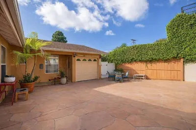 a house with a patio with chairs and a fence at Central Location Cozy Home Villa in San Diego