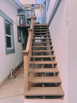 a wooden staircase leading up to a house at Beach Getaway Apt - Walk to Sand & Bay in San Diego