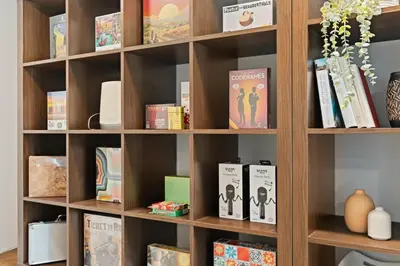 a book shelf filled with books and other items at Villa Tierra Alta - Pool, Spa, Movie Theater, Game Room in La Mesa