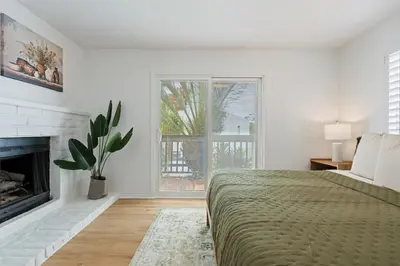 a white bedroom with a bed and a fireplace at Villa Tierra Alta - Pool, Spa, Movie Theater, Game Room in La Mesa