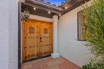 a pair of wooden doors on a house at Villa Tierra Alta - Pool, Spa, Movie Theater, Game Room in La Mesa