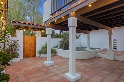 a house with a patio with a wooden door at Villa Tierra Alta - Pool, Spa, Movie Theater, Game Room in La Mesa