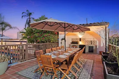 a wooden table with an umbrella on a patio at Villa Tierra Alta - Pool, Spa, Movie Theater, Game Room in La Mesa