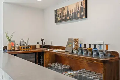 a kitchen with a counter with bottles and glasses at Villa Tierra Alta - Pool, Spa, Movie Theater, Game Room in La Mesa