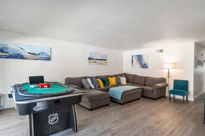 a living room with a couch and a table at 3BR Family Fun Home, Pool, Air Hockey&Patio Dining in Chula Vista