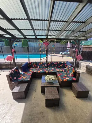 a patio with couches and chairs and a table at 3BR Family Fun Home, Pool, Air Hockey&Patio Dining in Chula Vista
