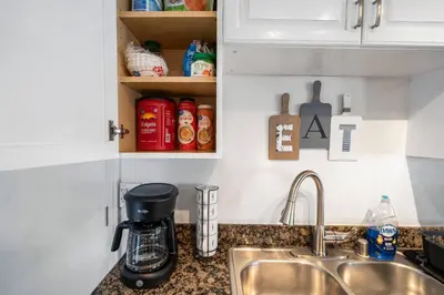 a kitchen counter with a coffee maker and a sink at 3BR Family Fun Home, Pool, Air Hockey&Patio Dining in Chula Vista