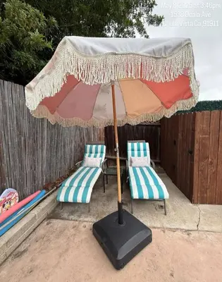 two chairs and an umbrella on a patio at 3BR Family Fun Home, Pool, Air Hockey&Patio Dining in Chula Vista