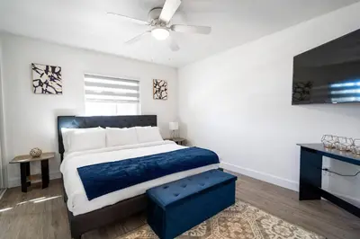 a bedroom with a large bed and a ceiling fan at 3BR Family Fun Home, Pool, Air Hockey&Patio Dining in Chula Vista