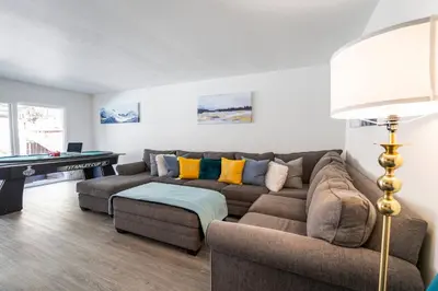 a living room with a couch and a pool table at 3BR Family Fun Home, Pool, Air Hockey&Patio Dining in Chula Vista