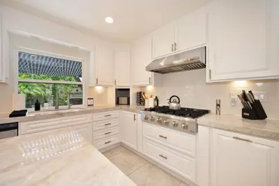 a kitchen with white cabinets and a stove top oven at Casa Fuerte - Valley Estate w Pool Hot Tub Sports Court in Temecula