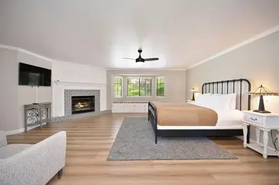 a white bedroom with a bed and a fireplace at Casa Fuerte - Valley Estate w Pool Hot Tub Sports Court in Temecula