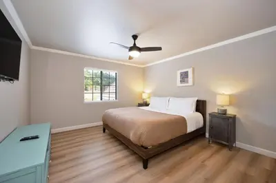 a bedroom with a bed and a ceiling fan at Casa Fuerte - Valley Estate w Pool Hot Tub Sports Court in Temecula