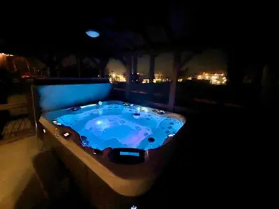 a jacuzzi tub on a balcony at night at Granite Hills Sunset Villa in El Cajon