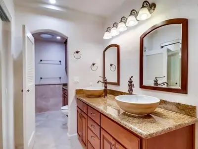 a bathroom with two sinks and a large mirror at Granite Hills Sunset Villa in El Cajon
