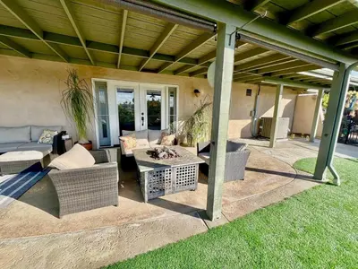 a covered patio with a couch and a table at Granite Hills Sunset Villa in El Cajon