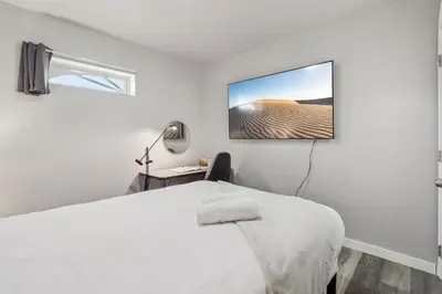 a bedroom with a bed and a desk and a window at Entire Private Home with 2 Bedrooms 1 Bathroom, Gated Yard, Driveway Parking, Available Now in Spring Valley
