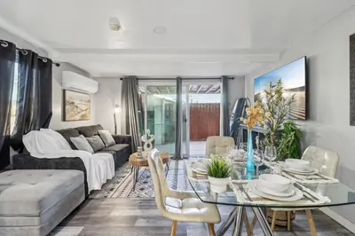 a living room with a table and a couch at Entire Private Home with 2 Bedrooms 1 Bathroom, Gated Yard, Driveway Parking, Available Now in Spring Valley