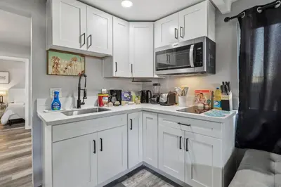 a kitchen with white cabinets and a microwave at Entire Private Home with 2 Bedrooms 1 Bathroom, Gated Yard, Driveway Parking, Available Now in Spring Valley