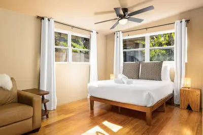 a bedroom with a white bed and a window at Carlsbad Zen - Large Pool in Carlsbad