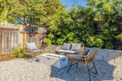 a patio with two chairs and a table and a couch at Carlsbad Bungalow Large Backyard in Carlsbad