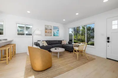 a living room with a couch and a table at Carlsbad Bungalow Large Backyard in Carlsbad