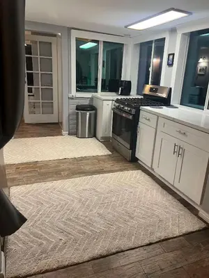 a kitchen with white cabinets and a stove at Redwing in San Marcos