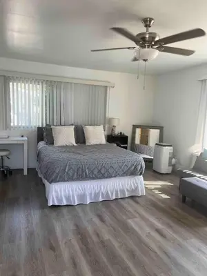 a bedroom with a bed and a ceiling fan at Redwing in San Marcos