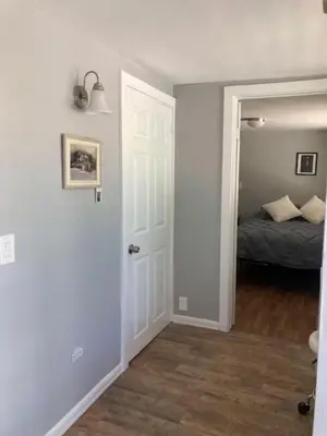 a bedroom with a door leading to a bed at Redwing in San Marcos