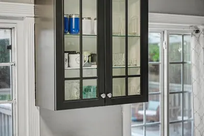 a black cabinet with glass doors in a kitchen at Charming La Mesa Cottage - Patio - Quiet Neighborhood - Family in La Mesa