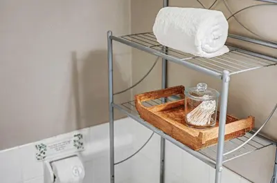 a metal shelf with a towel and a glass jar at Charming La Mesa Cottage - Patio - Quiet Neighborhood - Family in La Mesa
