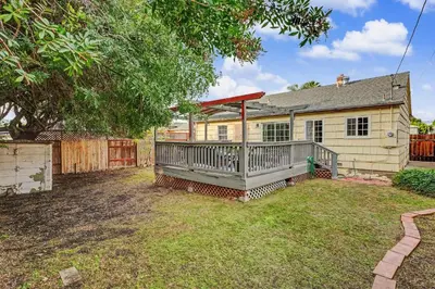 a house with a large deck in a yard at Charming La Mesa Cottage - Patio - Quiet Neighborhood - Family in La Mesa