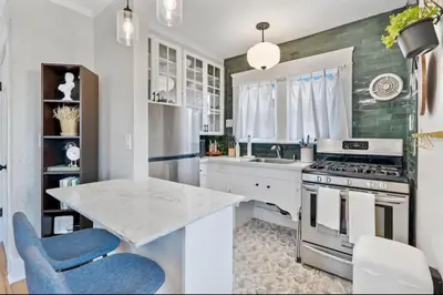 a kitchen with a sink and a stove top oven at The Downtown Carraige Flat in San Diego