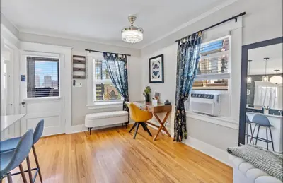 a living room with a table and chairs and a desk at The Downtown Carraige Flat in San Diego