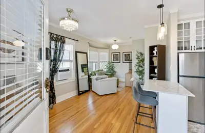 a kitchen and living room with a counter and a bar at The Downtown Carraige Flat in San Diego