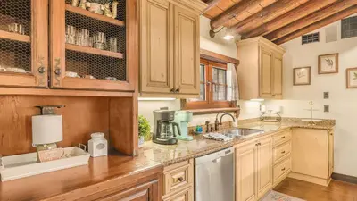 a kitchen with wooden cabinets and a counter top at Villa Di Gioia by AvantStay Private Wine-Country Estate Vineyard Views • Near Top Temecula Wineries in Temecula