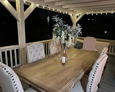 a wooden table with chairs and a bottle of wine at Amazing Ranch Home in Temecula wine country in Temecula