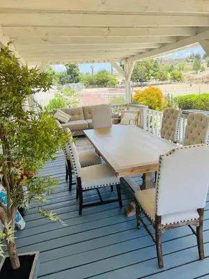 a wooden table and chairs on a deck at Amazing Ranch Home in Temecula wine country in Temecula