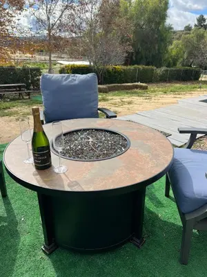 a table with a bottle of wine and two glasses at Amazing Ranch Home in Temecula wine country in Temecula
