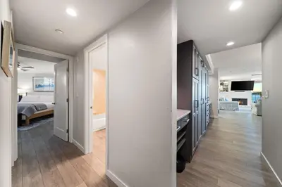 a hallway with a bedroom and a living room at Sunset on Sail Bay - Beautiful 2 Bedroom Condo in San Diego