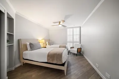a white bedroom with a bed and a window at Sunset on Sail Bay - Beautiful 2 Bedroom Condo in San Diego
