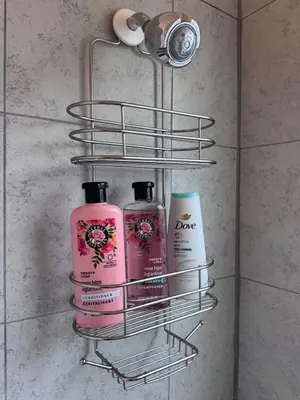a rack with three shampoo and conditioners in a bathroom at Cozy 1bed Home near Down Town SD in San Diego
