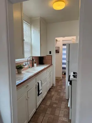 a kitchen with a sink and a refrigerator at Cozy 1bed Home near Down Town SD in San Diego