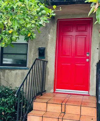 a red door on the side of a house at Cozy 1bed Home near Down Town SD in San Diego